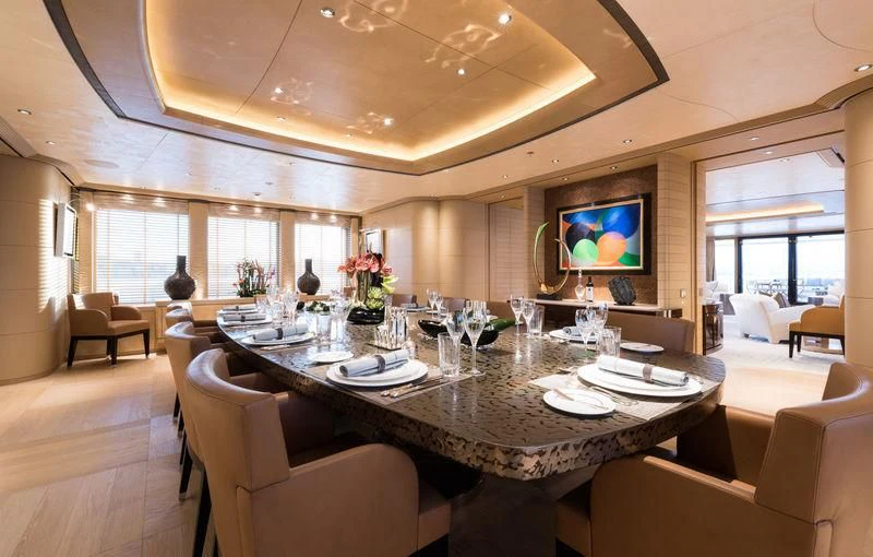 a large dining room with a large table and chairs aboard ROMEA Yacht for Sale