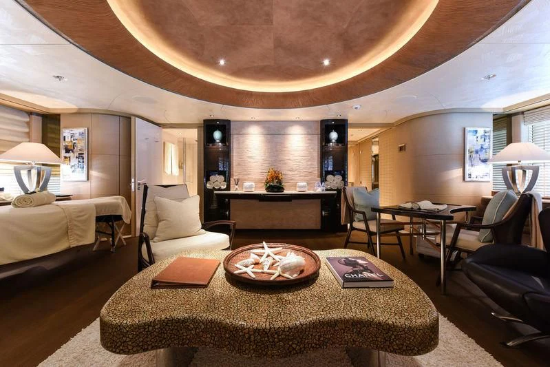 a living room with a table and chairs aboard ROMEA Yacht for Sale