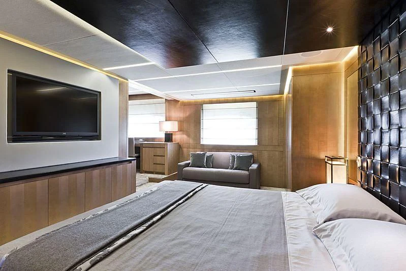 a bed and a couch in a room aboard LE CAPRICE IV Yacht for Sale
