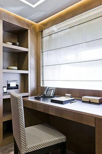 a desk with a phone and a chair aboard LE CAPRICE IV Yacht for Sale