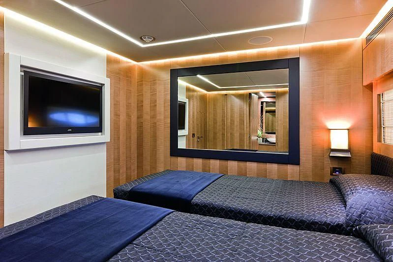 a bedroom with a bed and a tv aboard LE CAPRICE IV Yacht for Sale