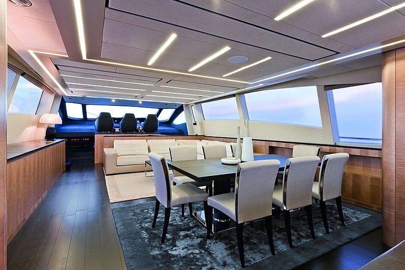 a room with a table and chairs aboard LE CAPRICE IV Yacht for Sale