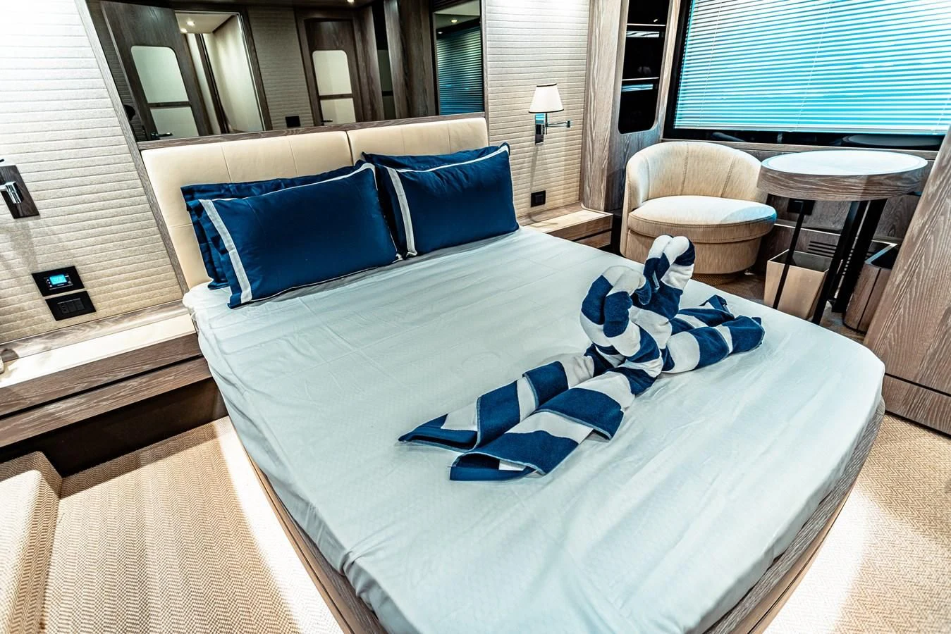 a bed with blue pillows aboard FAT BOY Yacht for Sale