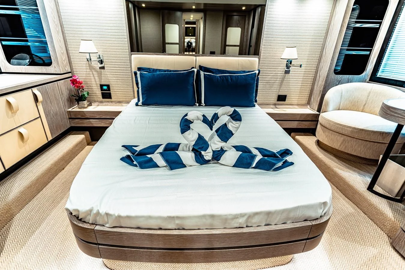 a large bed with blue pillows aboard FAT BOY Yacht for Sale