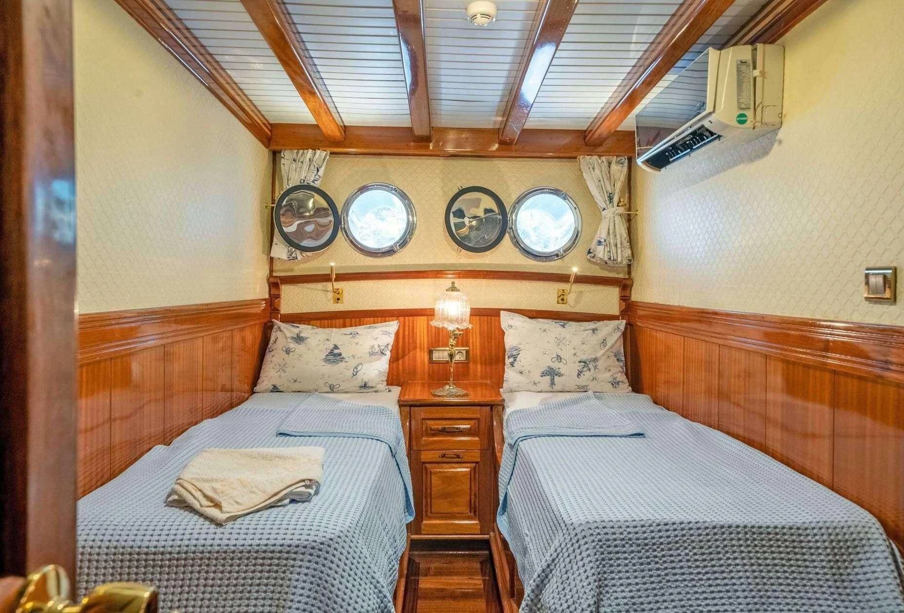 a couple of beds in a room aboard ADMIRAL Yacht for Charter