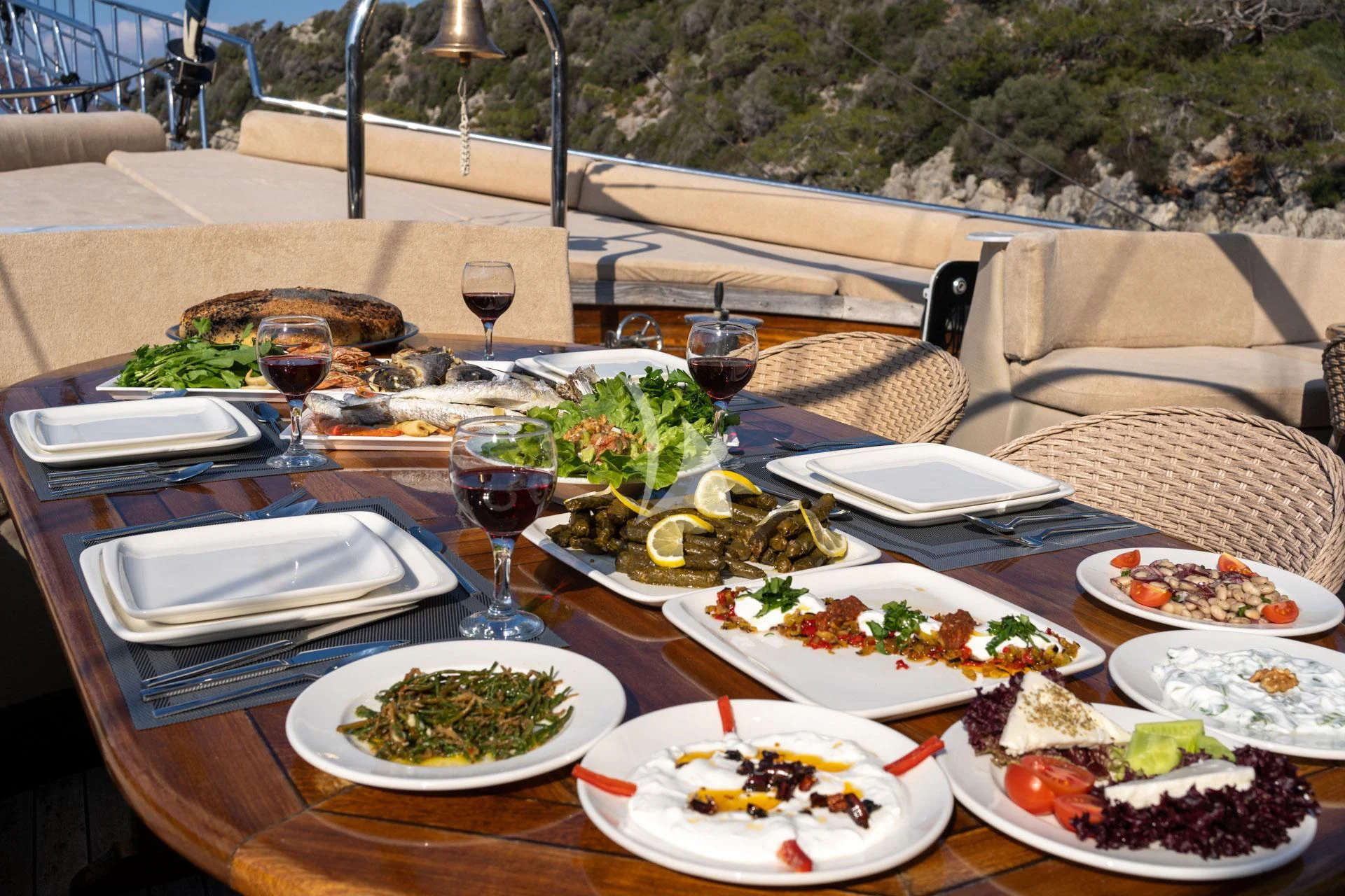 a table with plates and food on it aboard ADMIRAL Yacht for Charter