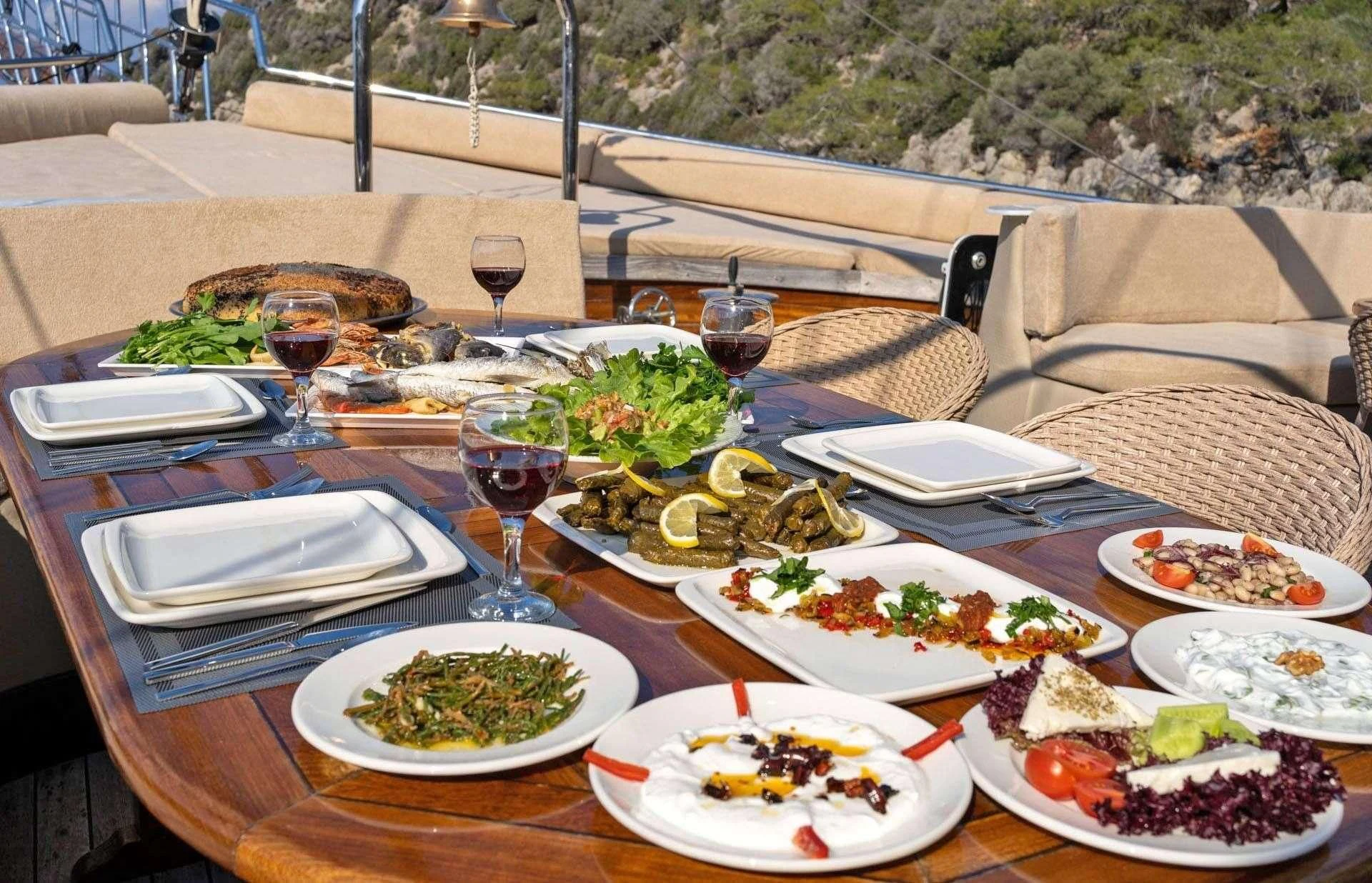 a table with food and wine aboard ADMIRAL Yacht for Charter