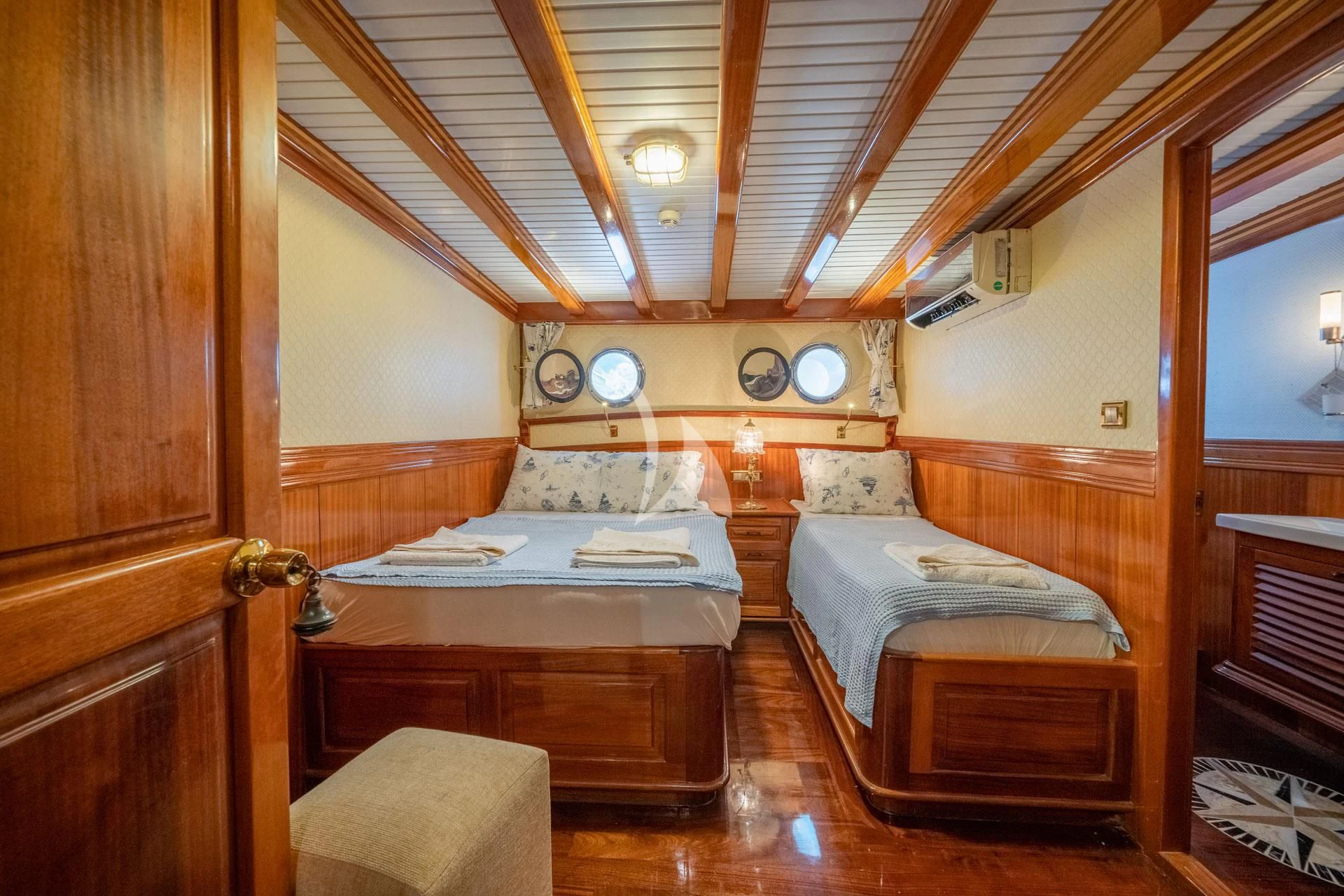 a couple of beds in a room aboard ADMIRAL Yacht for Charter