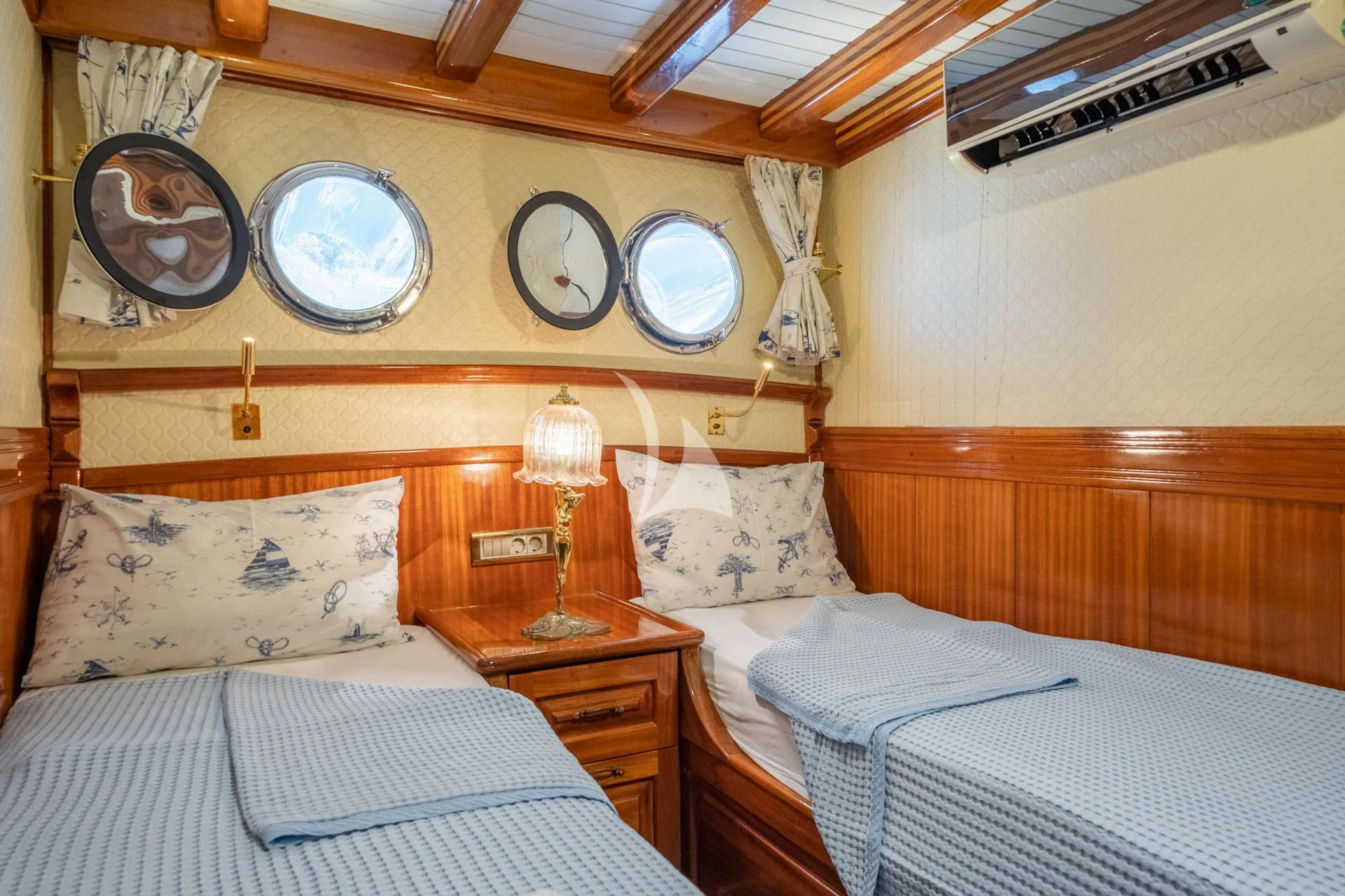 a couple of beds in a room aboard ADMIRAL Yacht for Charter