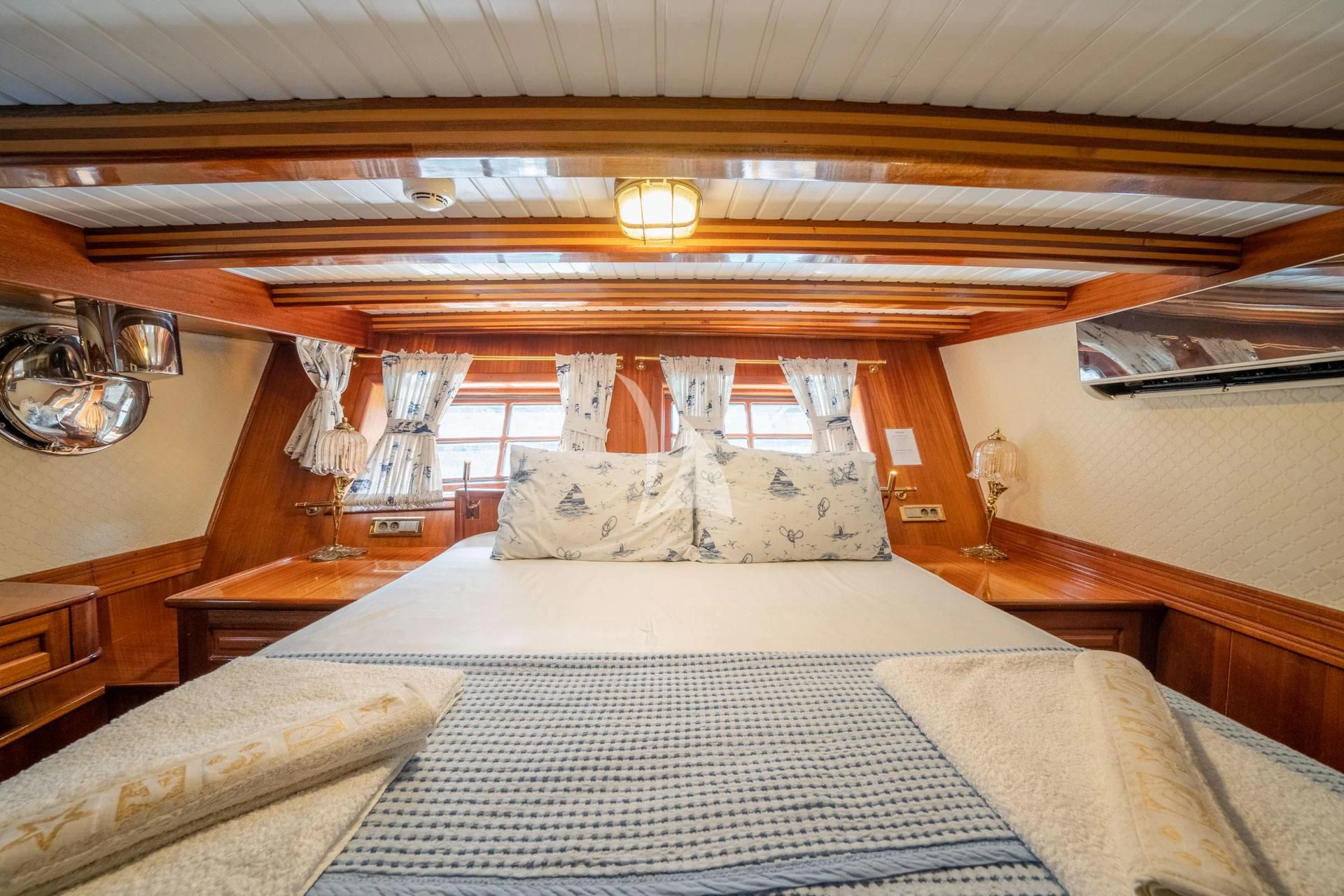 a bedroom with a bed and a window aboard ADMIRAL Yacht for Charter