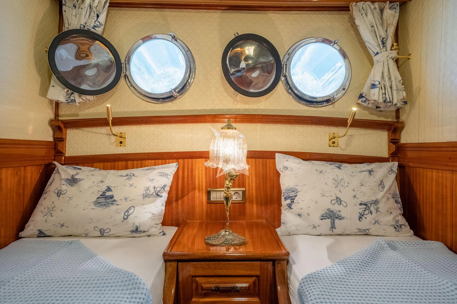 a bed with a mirror above it aboard ADMIRAL Yacht for Charter