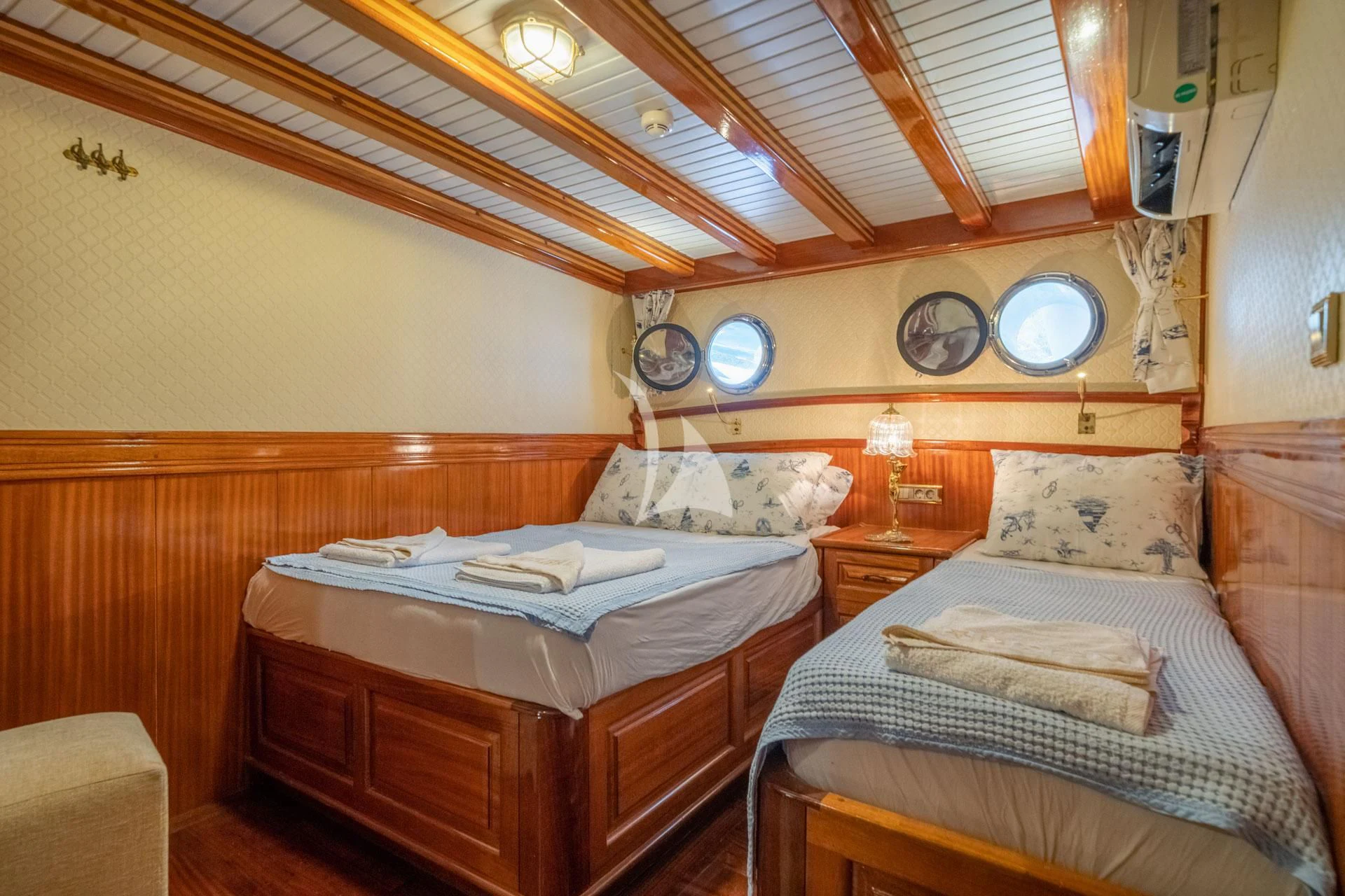 a couple of beds in a room aboard ADMIRAL Yacht for Charter
