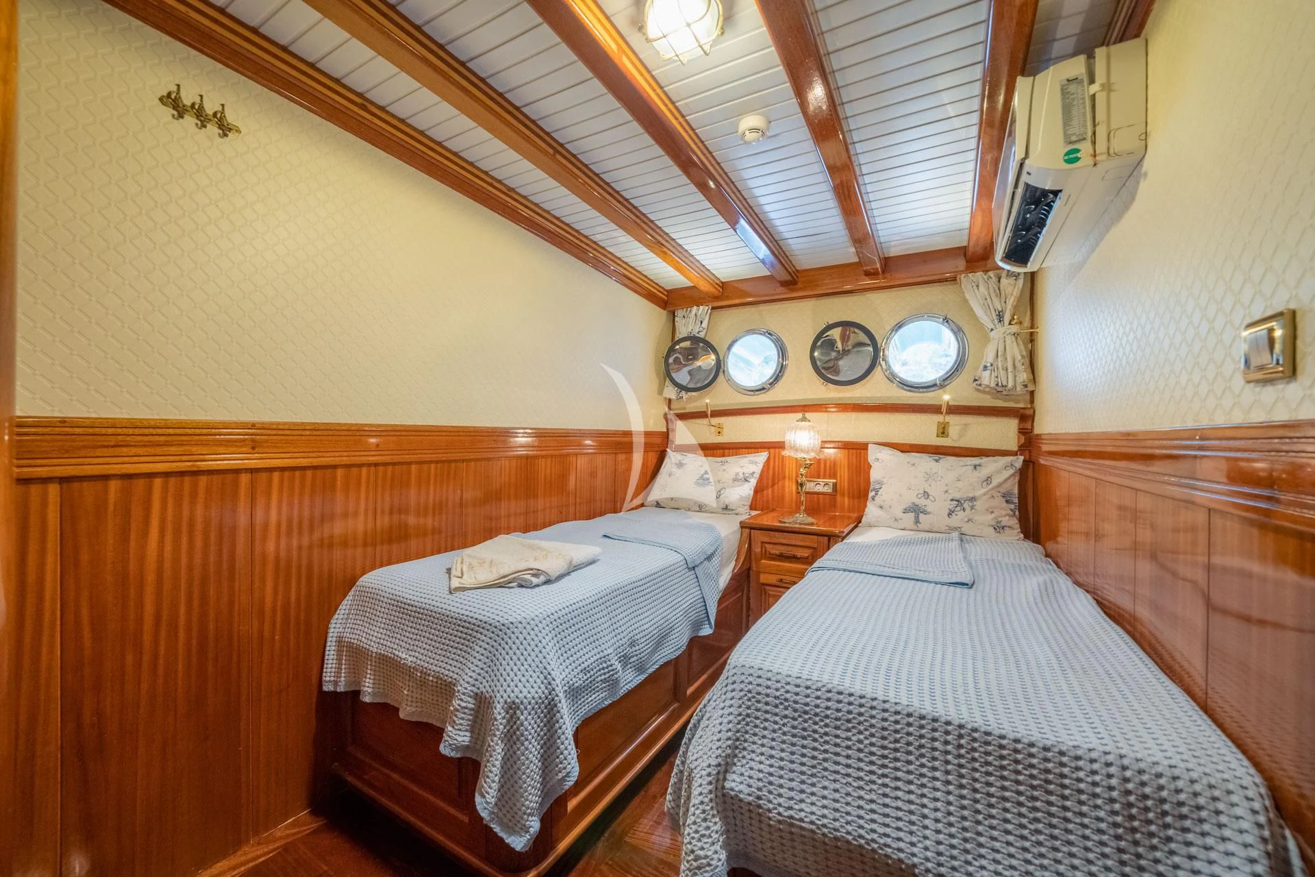 a couple of beds in a hotel room aboard ADMIRAL Yacht for Charter