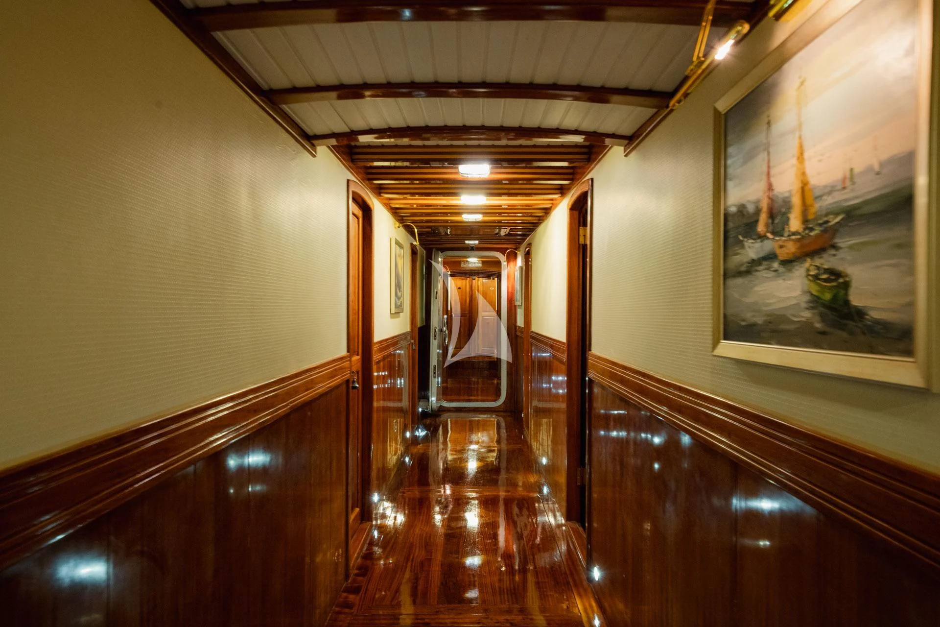 a hallway with wood floors and a painting on the wall aboard ADMIRAL Yacht for Charter