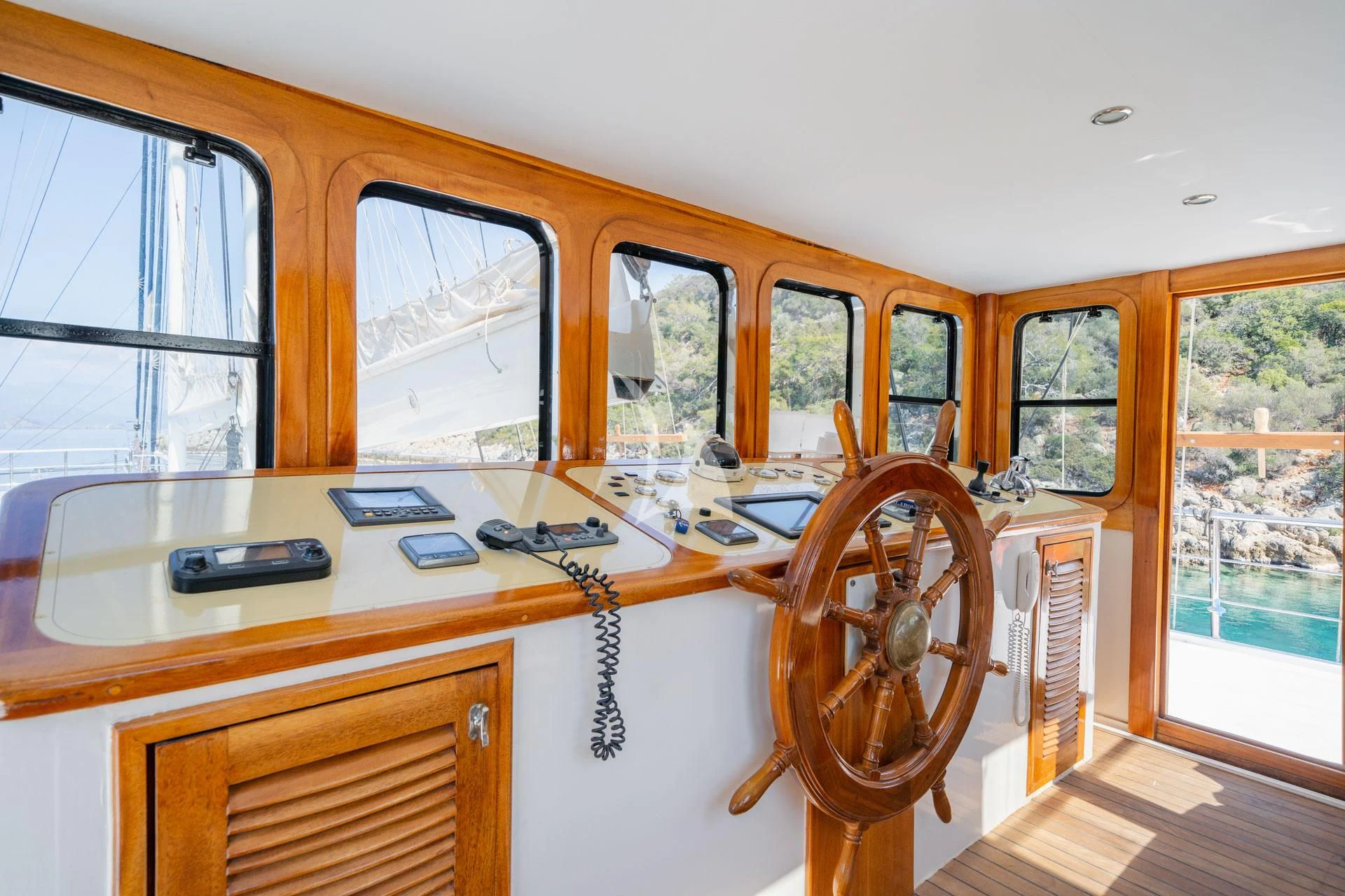 a wooden desk with a computer on it aboard ADMIRAL Yacht for Charter