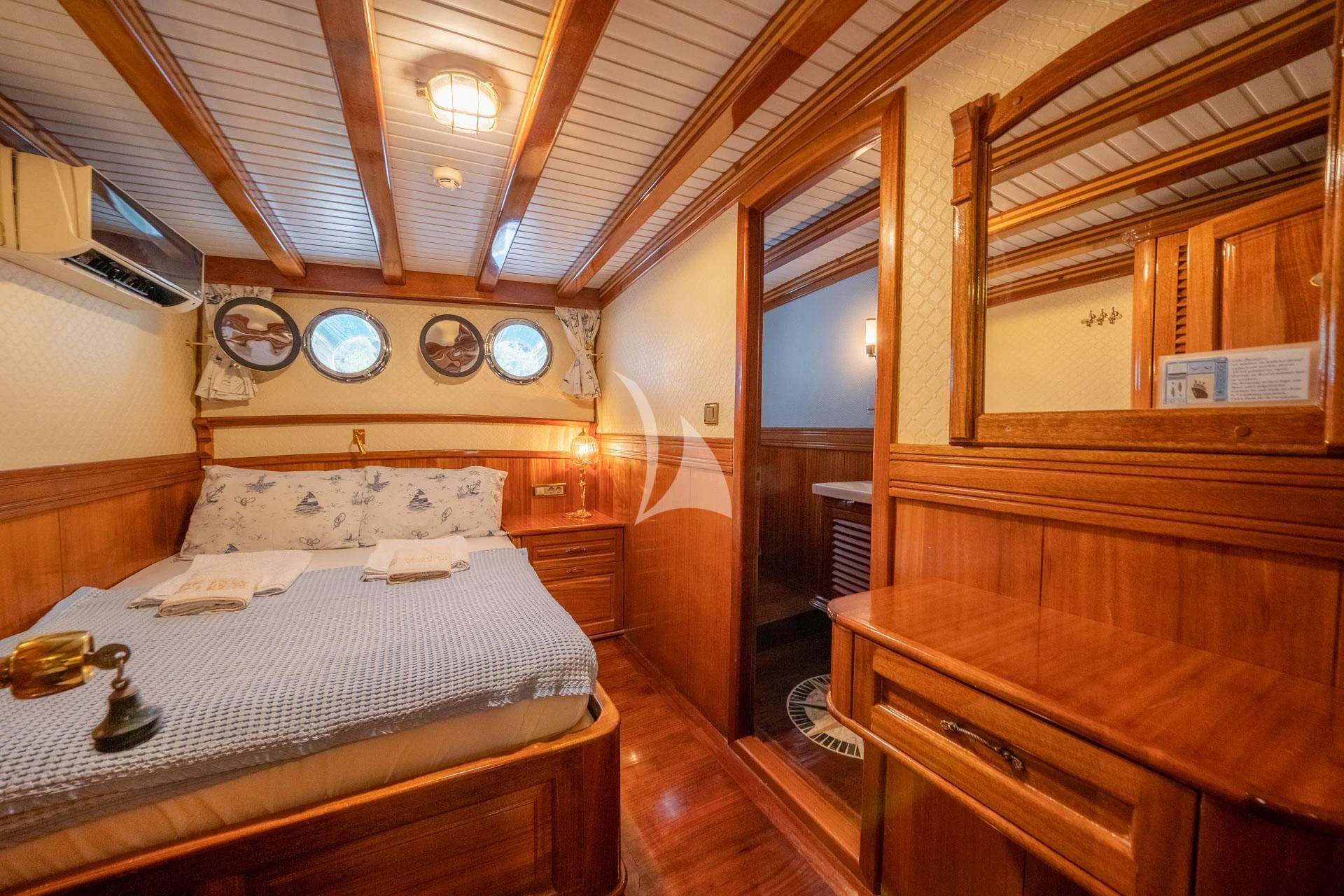 a bedroom with a bed and a desk aboard ADMIRAL Yacht for Charter