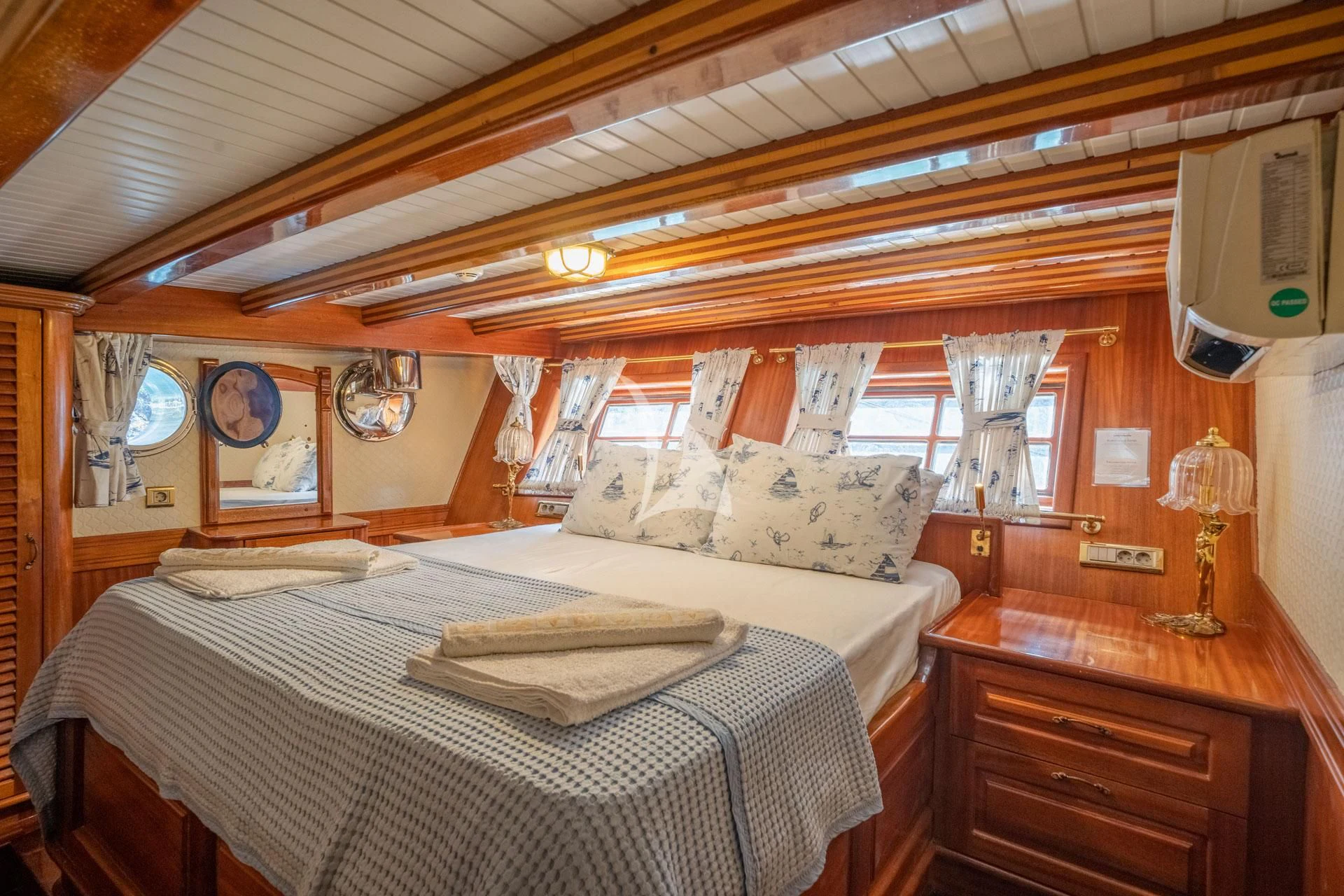 a bedroom with a bed and a dresser aboard ADMIRAL Yacht for Charter