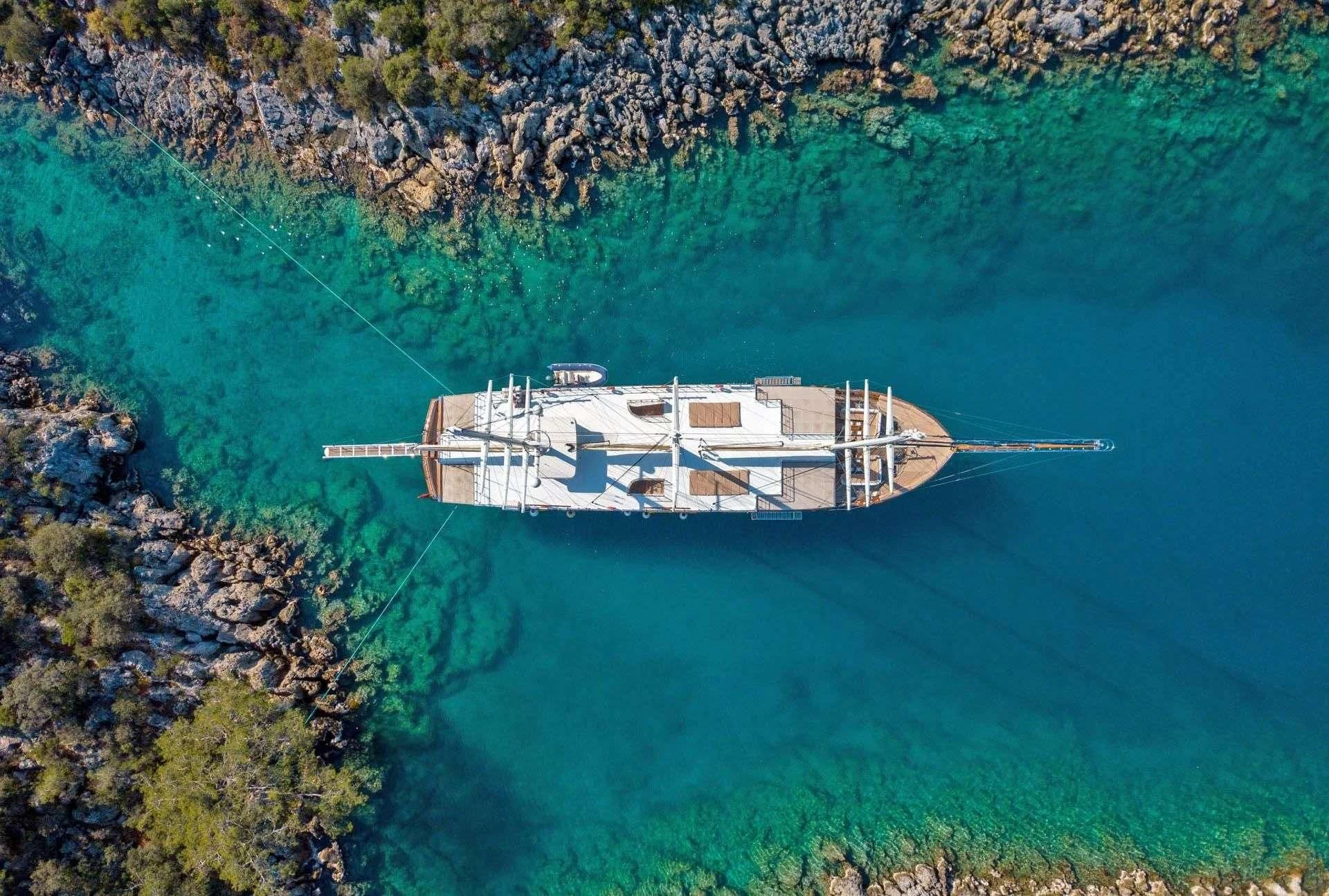 a building on a cliff above water aboard ADMIRAL Yacht for Charter