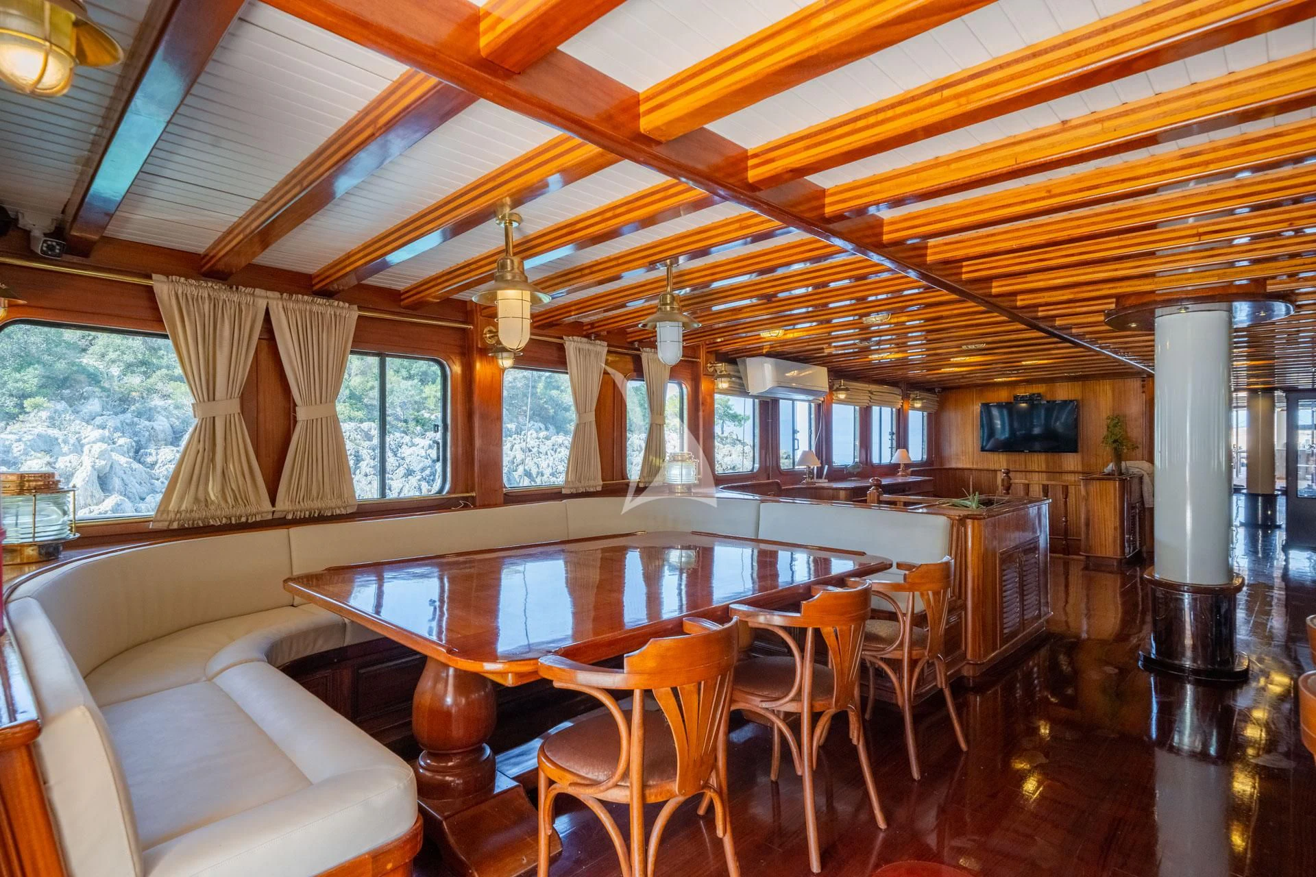 a large dining room with a large table and chairs aboard ADMIRAL Yacht for Charter