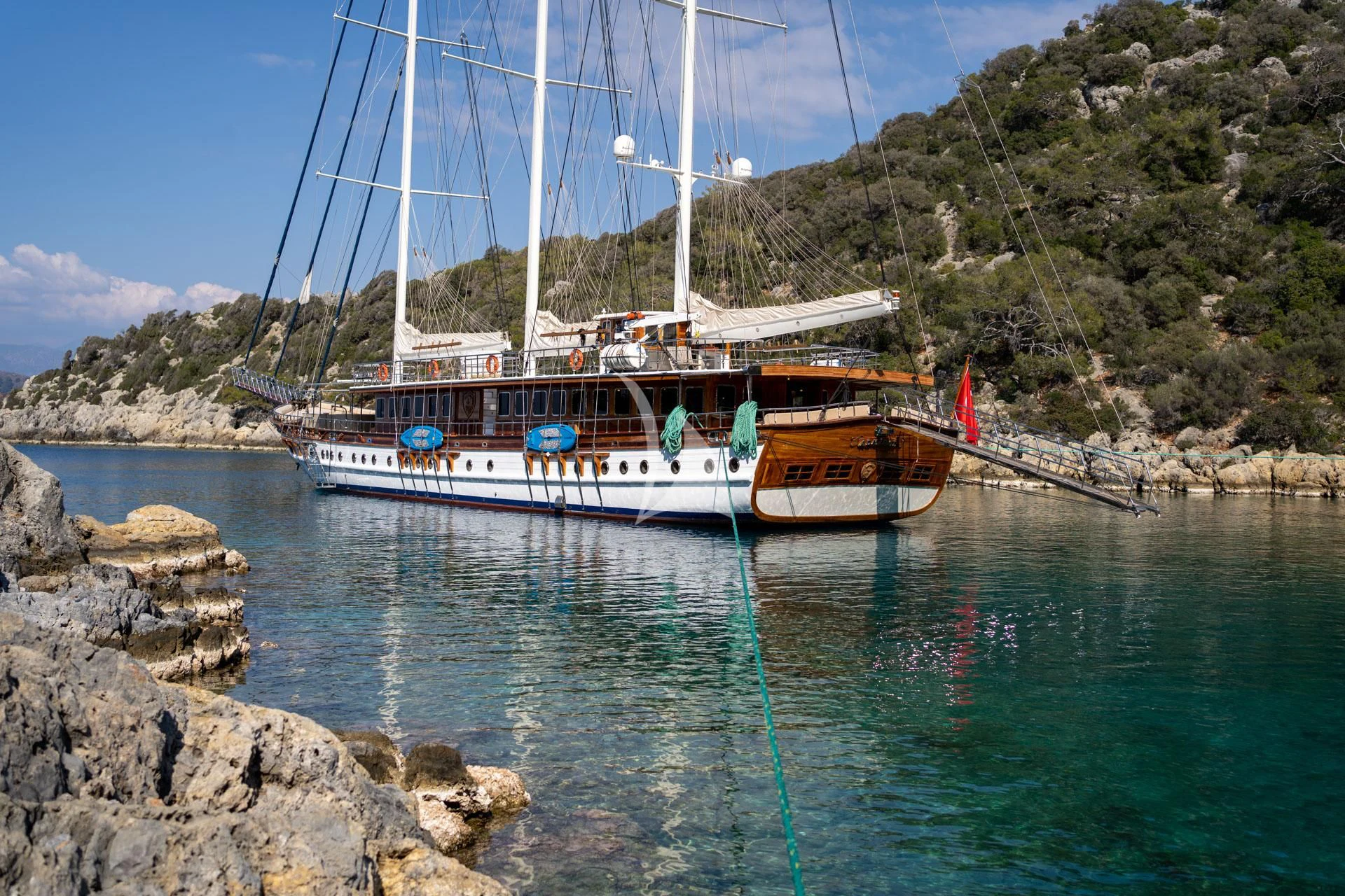 a boat tied to a rock aboard ADMIRAL Yacht for Charter