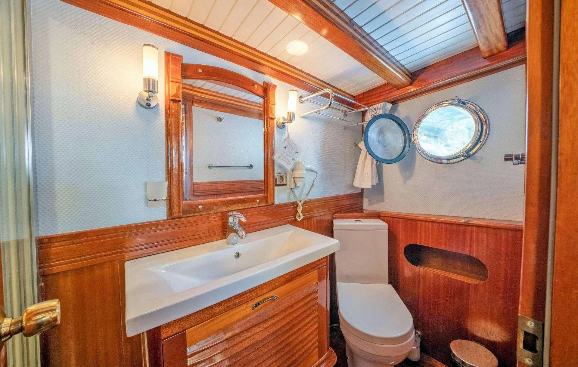 a bathroom with a sink and toilet aboard ADMIRAL Yacht for Charter