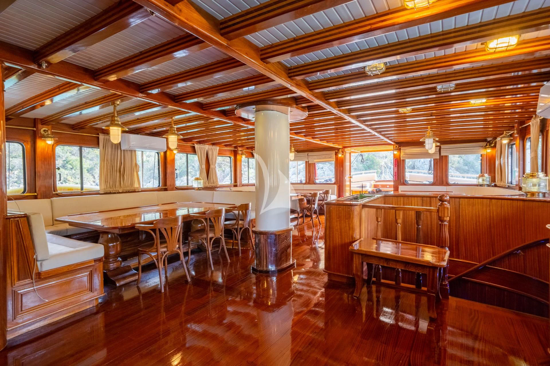 a large room with tables and chairs aboard ADMIRAL Yacht for Charter