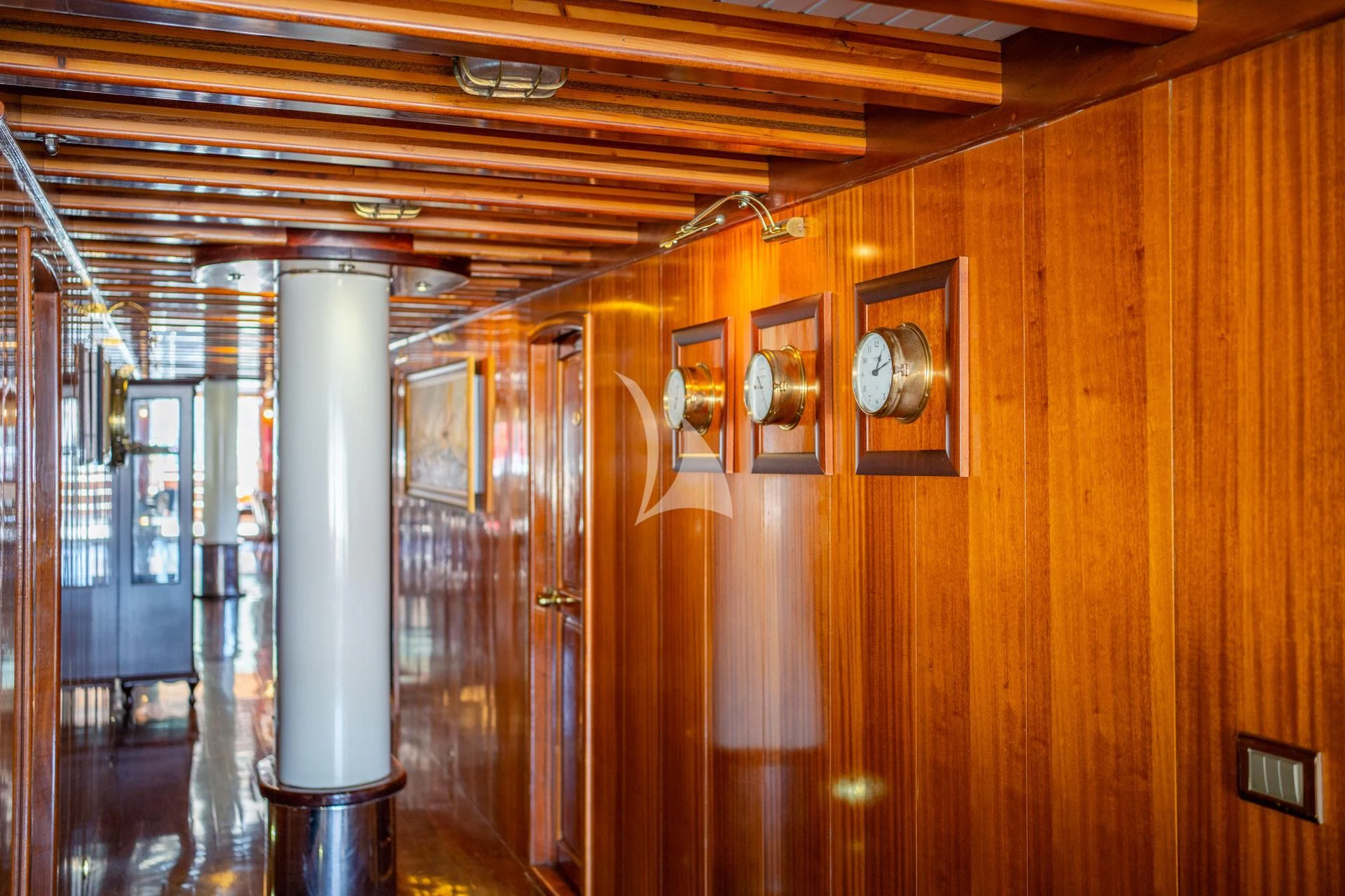 a room with wood walls and a light from the ceiling aboard ADMIRAL Yacht for Charter