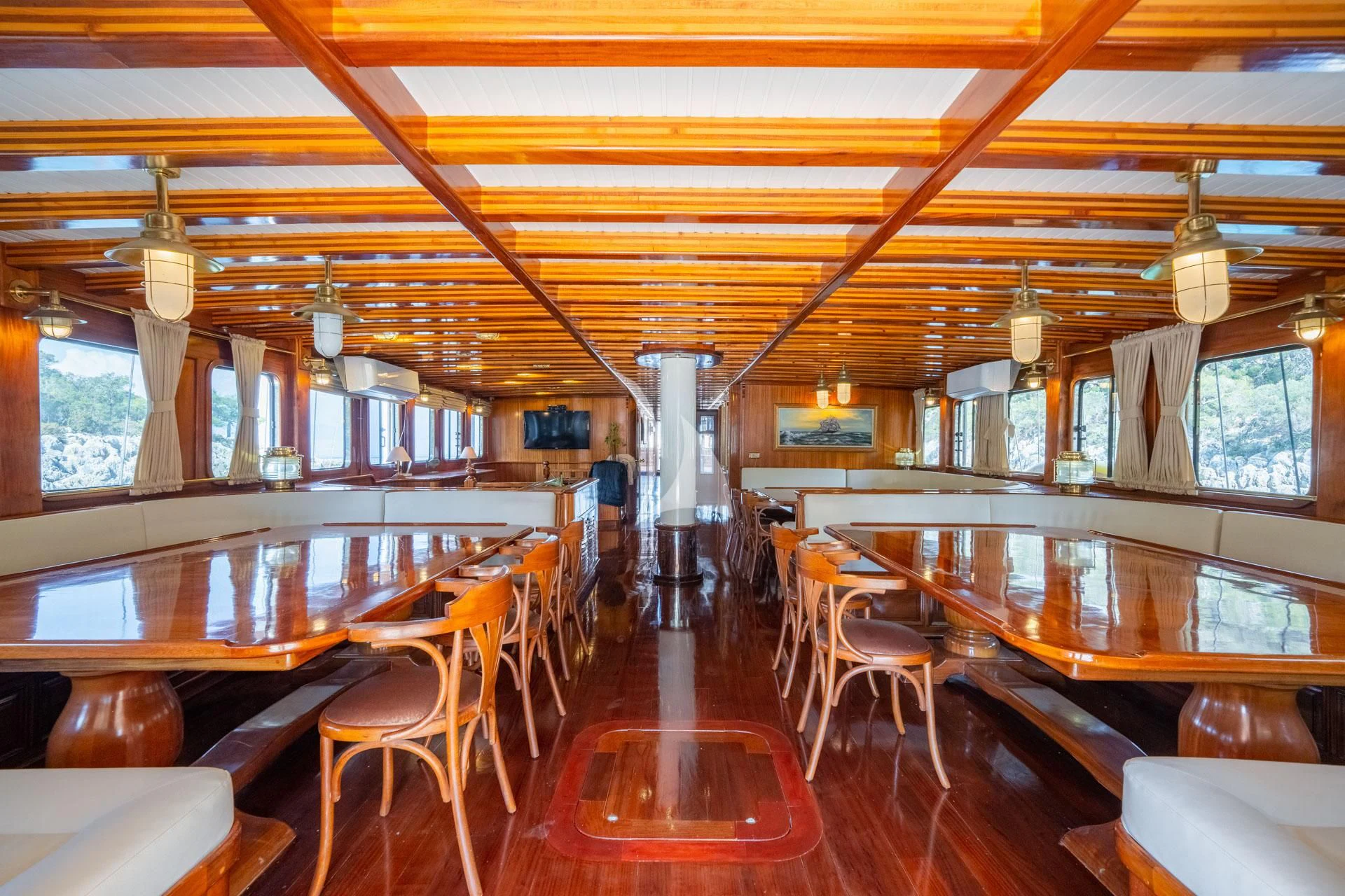 inside of a building with tables and chairs aboard ADMIRAL Yacht for Charter