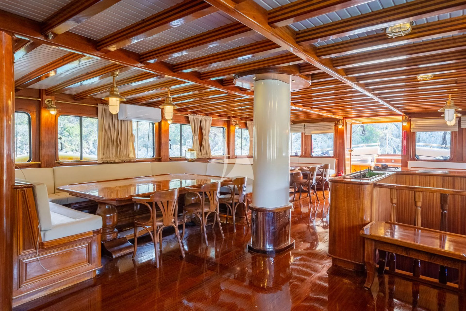 a large room with tables and chairs aboard ADMIRAL Yacht for Charter