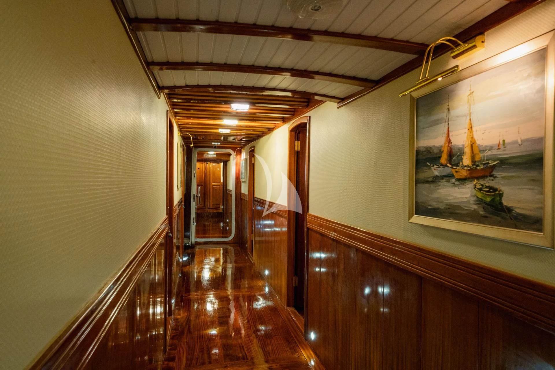 a hallway with a large painting on the wall aboard ADMIRAL Yacht for Charter