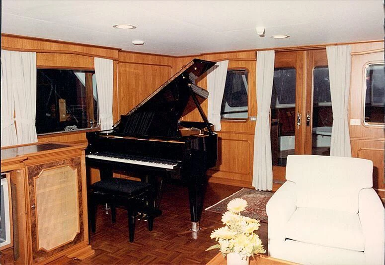 a piano in a living room aboard ORION Yacht for Sale