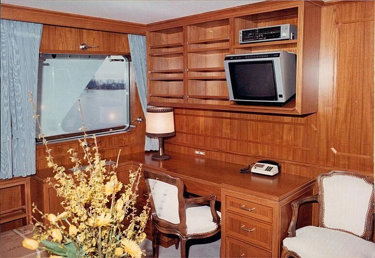 a living room with a tv and flowers aboard ORION Yacht for Sale