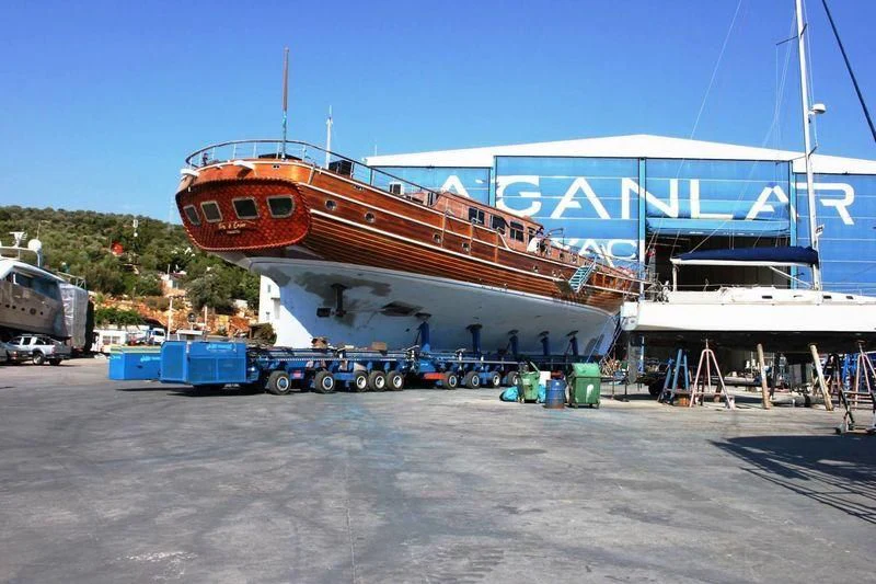 a large boat docked at a port aboard TAKE IT EASIER Yacht for Sale