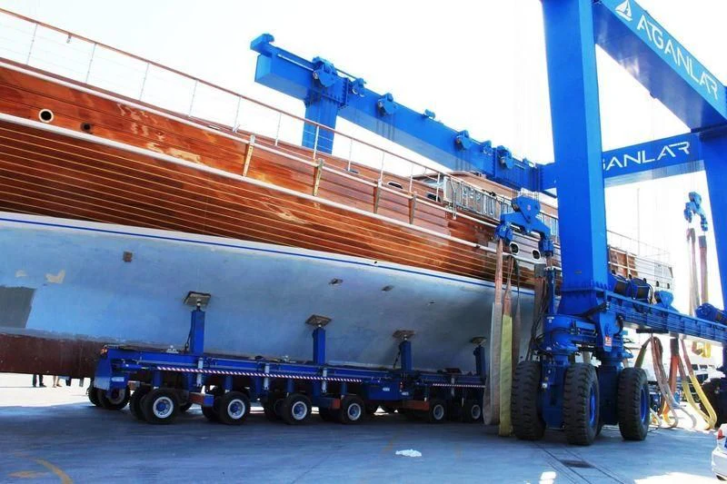 a semi truck hauling a trailer aboard TAKE IT EASIER Yacht for Sale