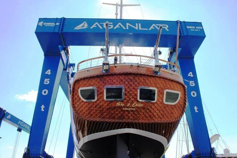 a red and white boat aboard TAKE IT EASIER Yacht for Sale