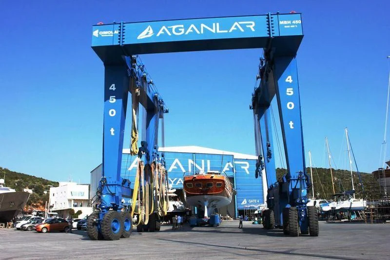 a large crane lifting a boat aboard TAKE IT EASIER Yacht for Sale