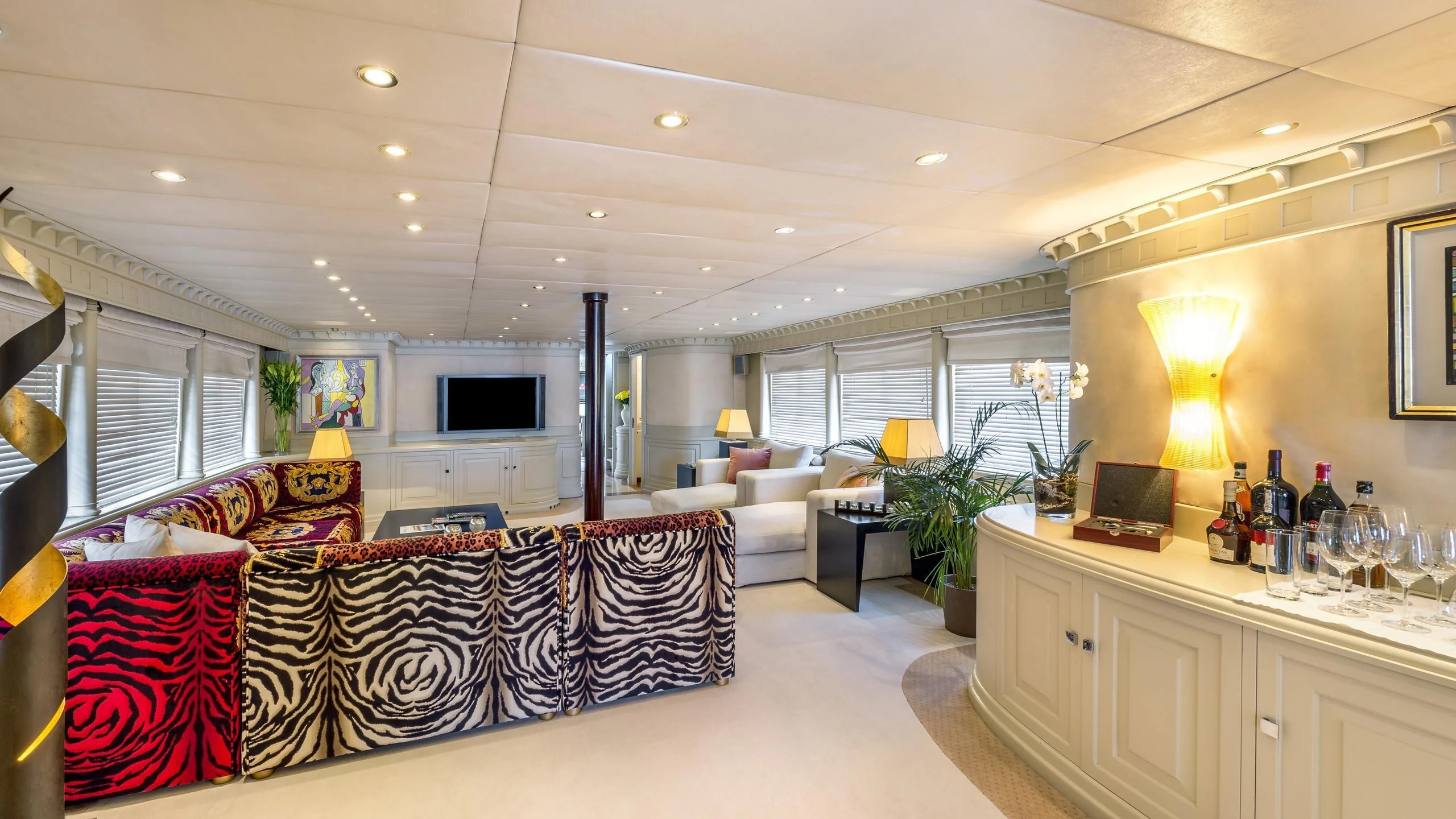 a living room with a couch and a tv aboard SUPERMAX Yacht for Sale