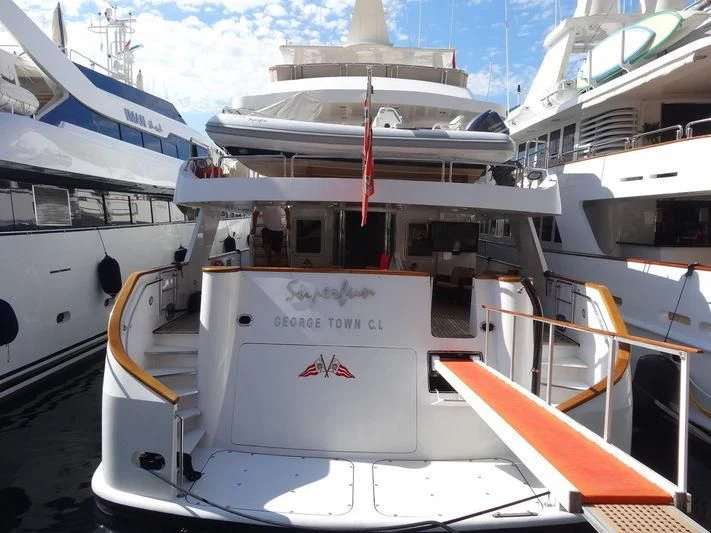 a boat docked at a pier aboard SUPERMAX Yacht for Sale