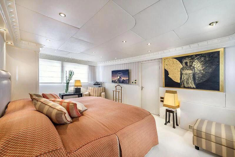 a bedroom with a bed and a desk aboard SUPERMAX Yacht for Sale