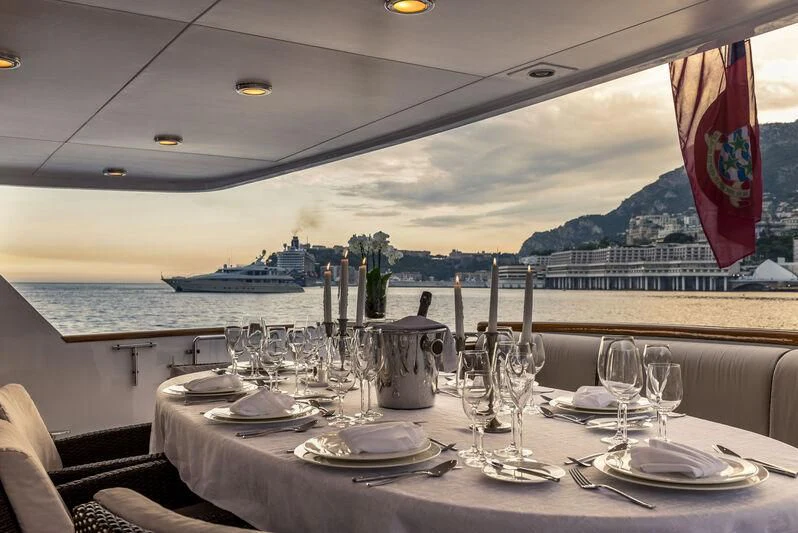 a table set for a dinner aboard SUPERMAX Yacht for Sale
