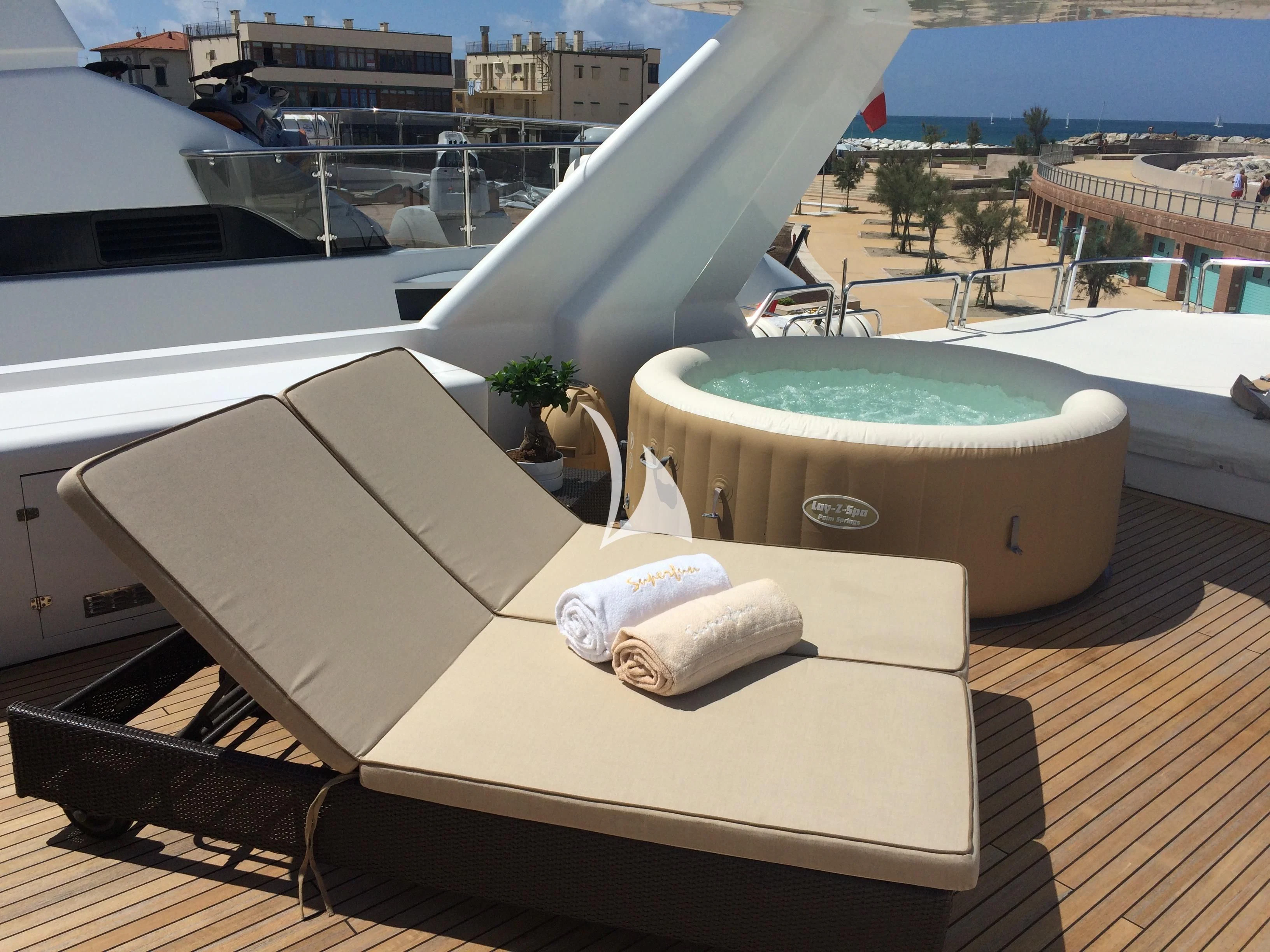 a room with a pool and a large building with a balcony aboard SUPERMAX Yacht for Sale