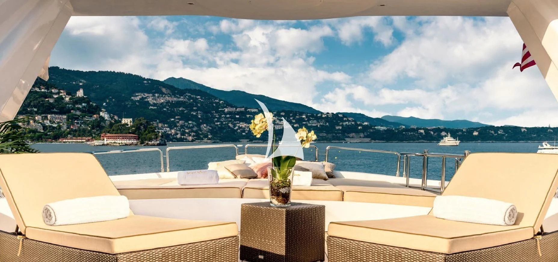 a room with a table and chairs and a plant on the table aboard SUPERMAX Yacht for Sale
