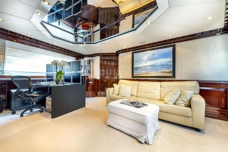 a living room with a couch and a tv aboard SUPERMAX Yacht for Sale