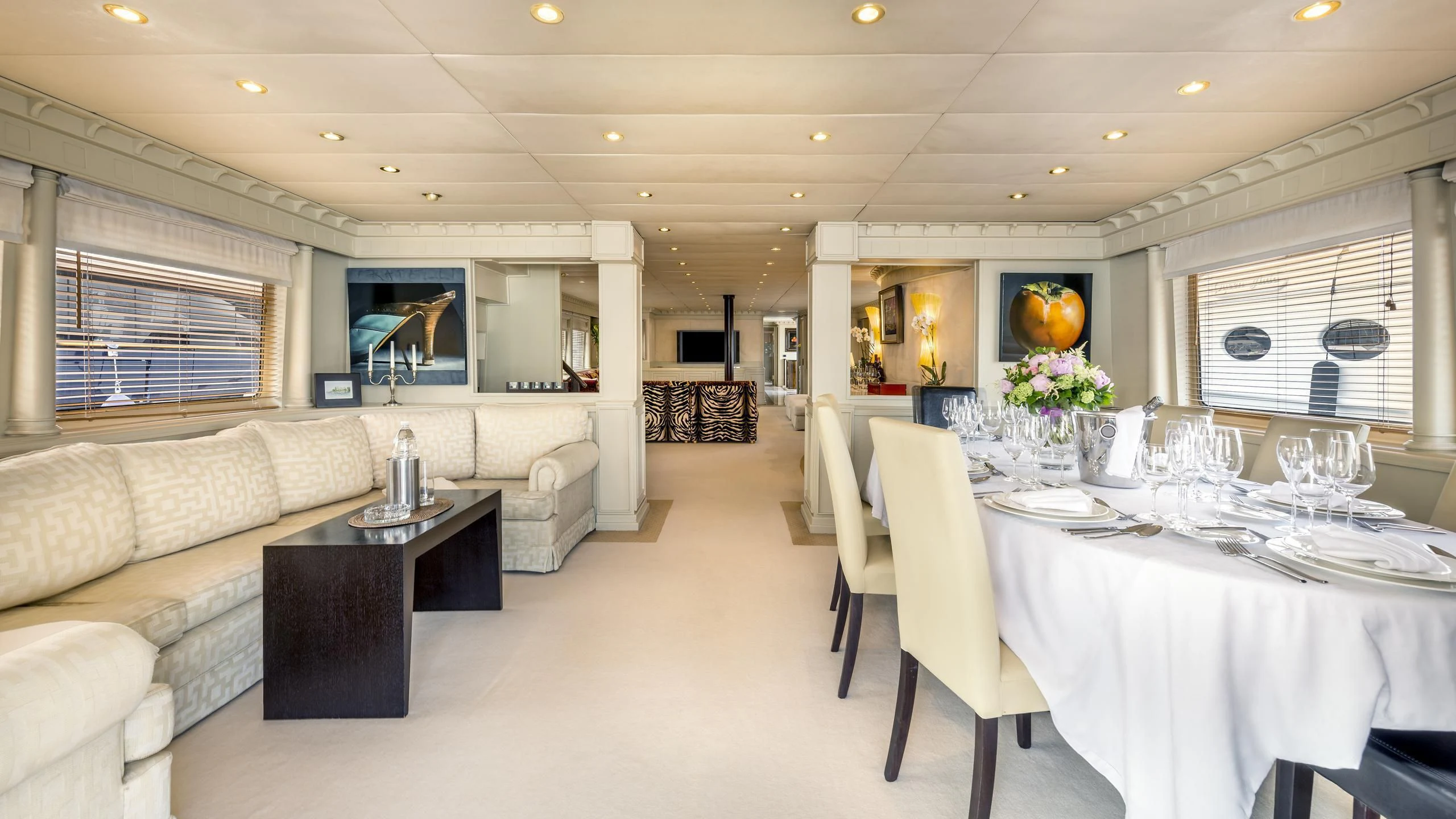a large room with a table and chairs aboard SUPERMAX Yacht for Sale