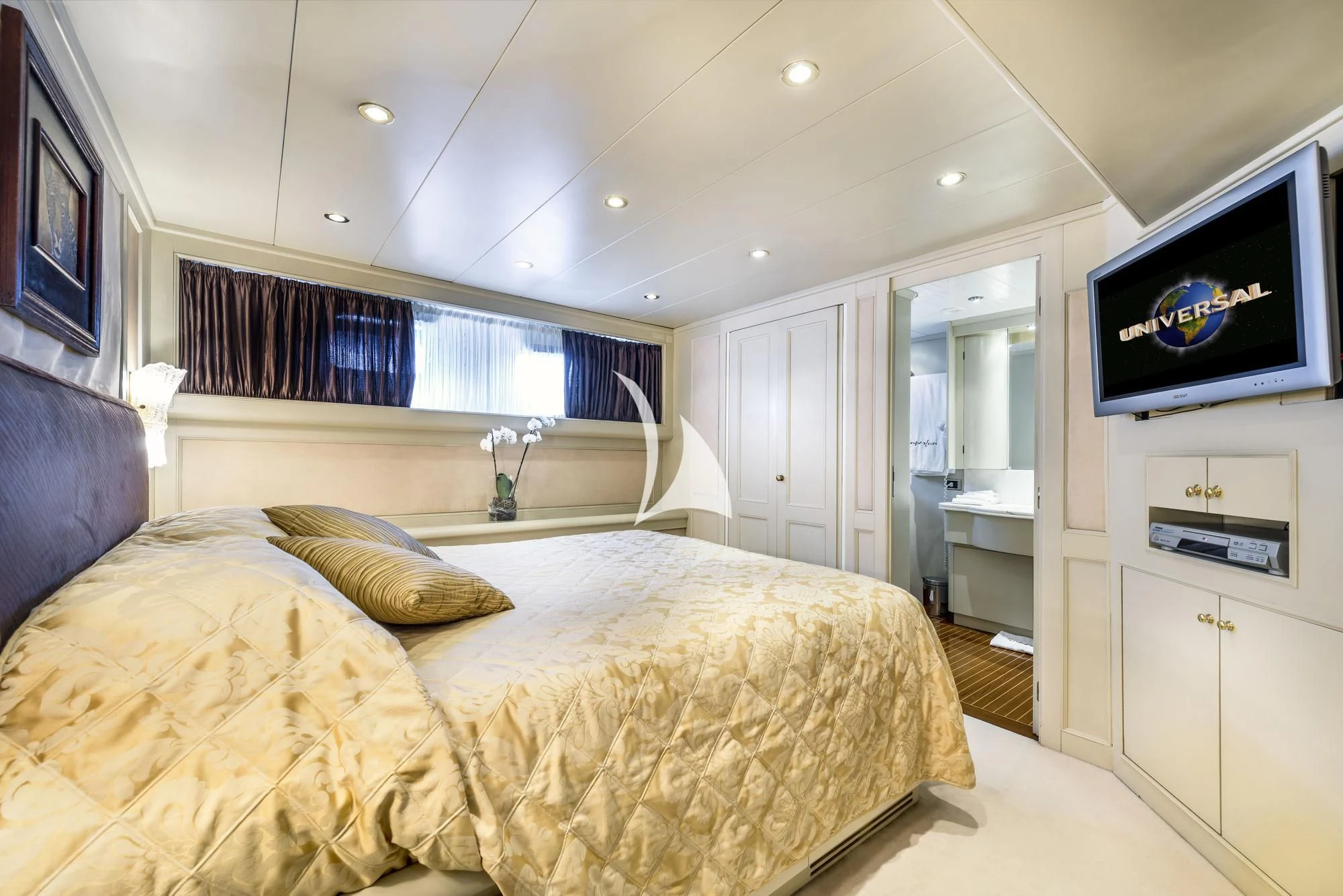 a bedroom with a bed and a tv on the wall aboard SUPERMAX Yacht for Sale
