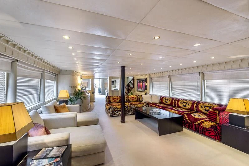 a living room with a couch and a table aboard SUPERMAX Yacht for Sale