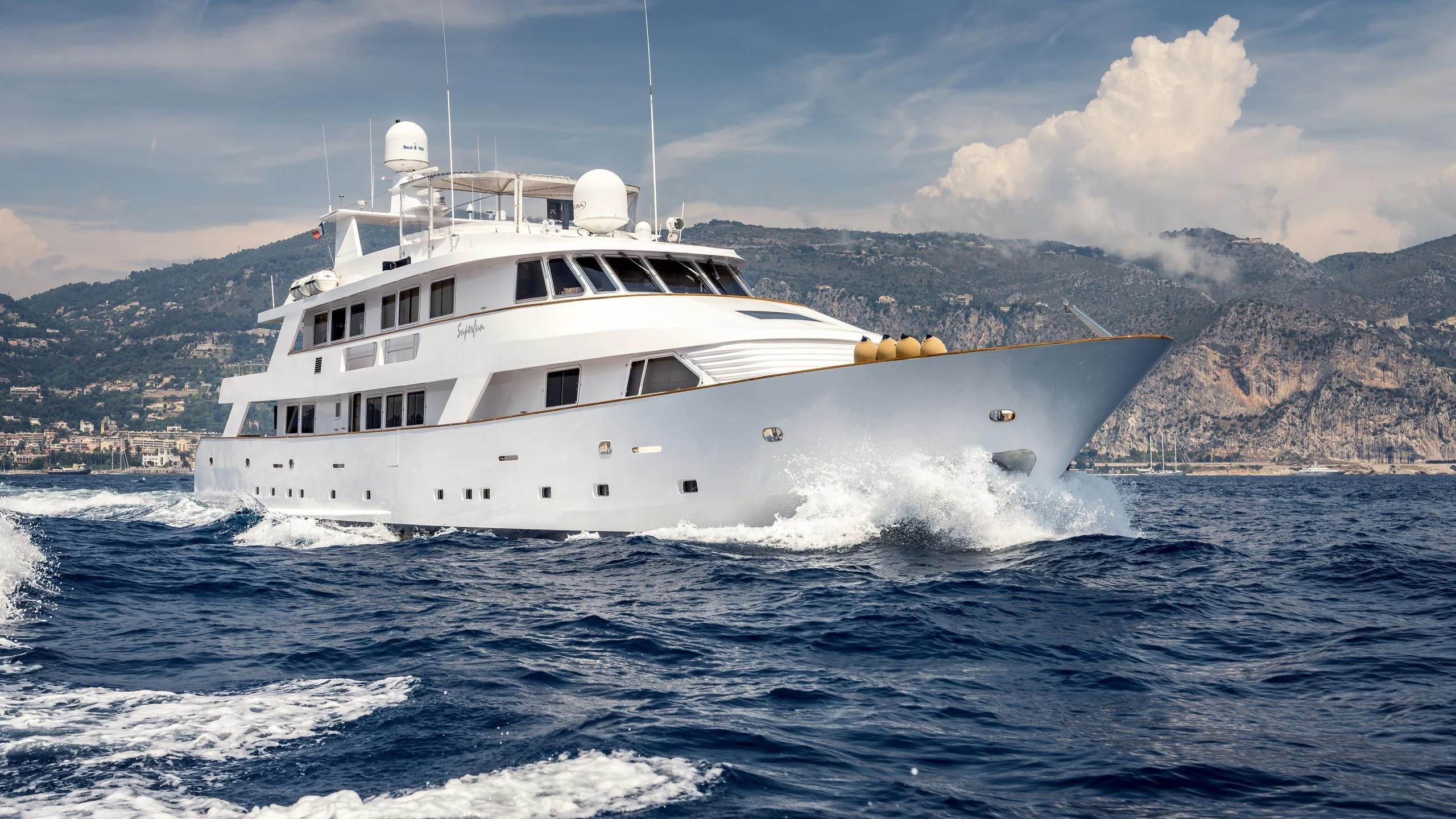 a white yacht on the water aboard SUPERMAX Yacht for Sale
