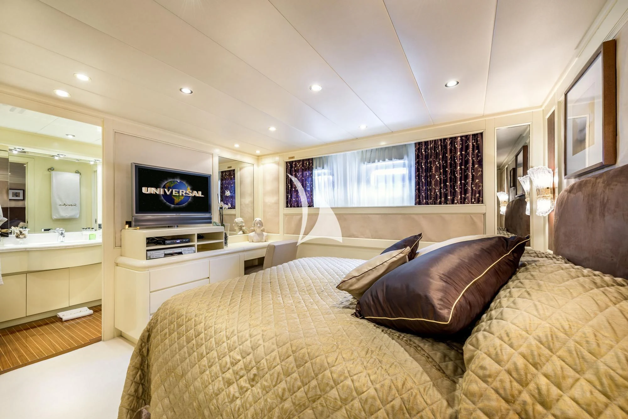 a bedroom with a bed and a tv aboard SUPERMAX Yacht for Sale
