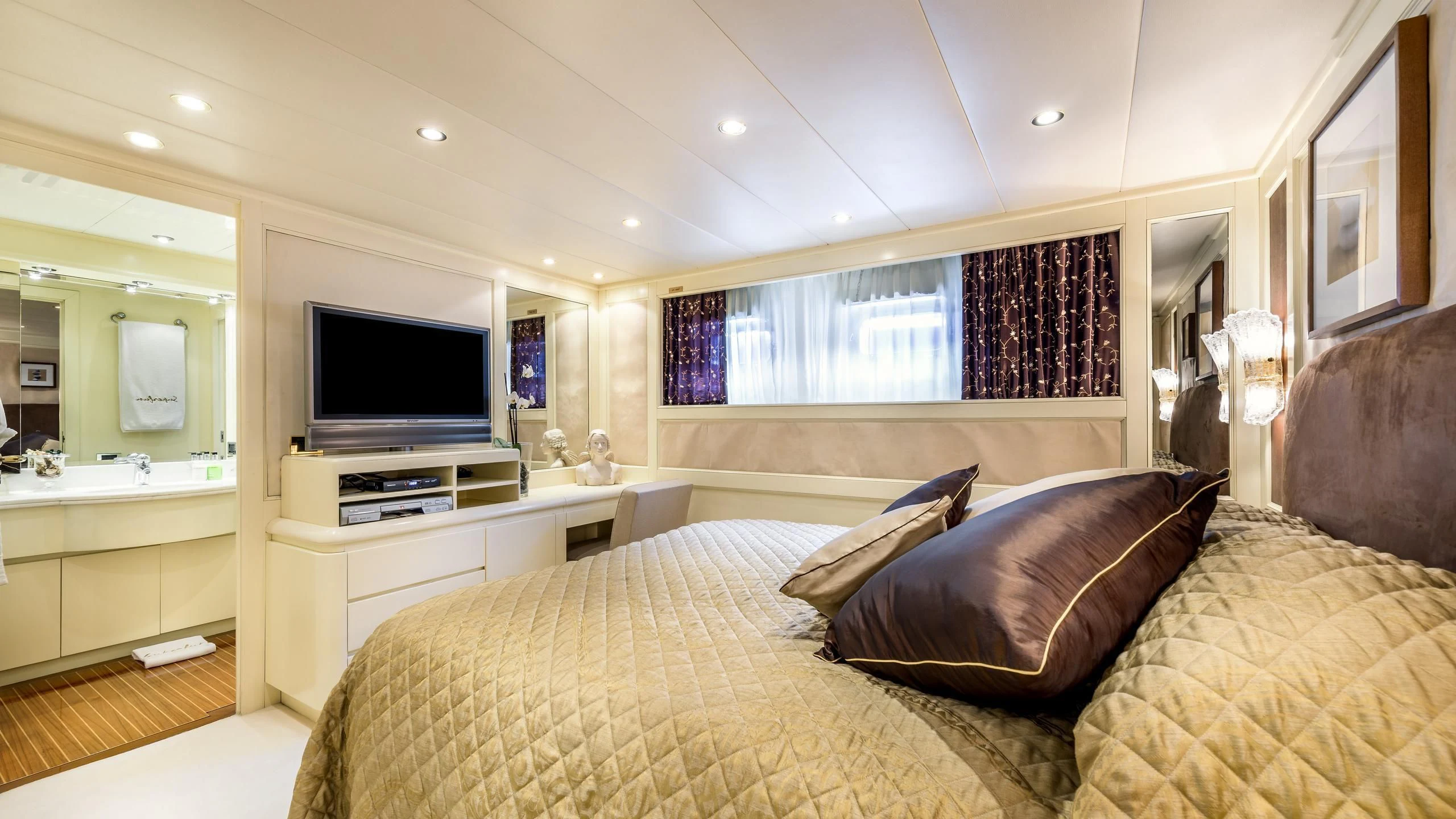 a bedroom with a bed and a television aboard SUPERMAX Yacht for Sale