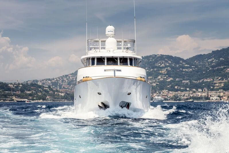 a white boat on water aboard SUPERMAX Yacht for Sale